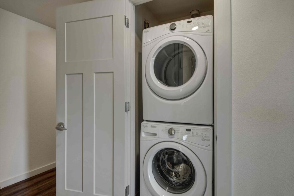 Laundry closet with a stacked washer and dryer.