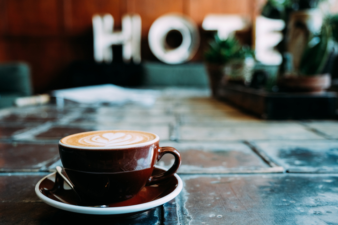 Cup of coffee on wooden table in coffee shop